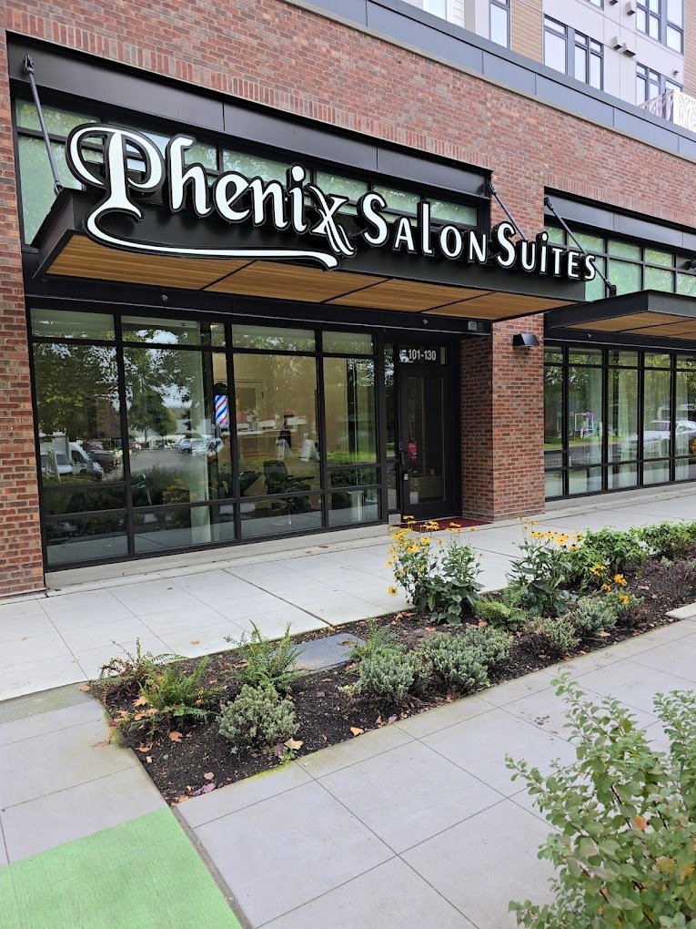 Street entrance to European Barber at 17645 NE 69th Ct, Redmond, under the Phenix Salon Suites sign at Spectra Apartments